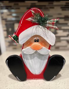 a santa clause figurine sitting on top of a counter