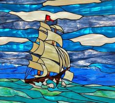 a stained glass window with a ship in the ocean