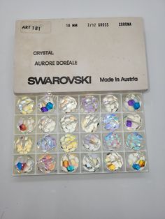 an assortment of swaroski glass beads in a box