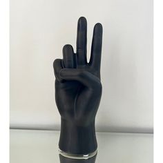 a black plastic hand with two fingers sticking out