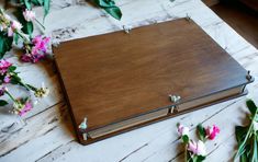 a wooden book with flowers on the table