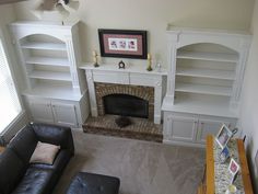 an overhead view of a living room with fireplace and built - in bookshelves