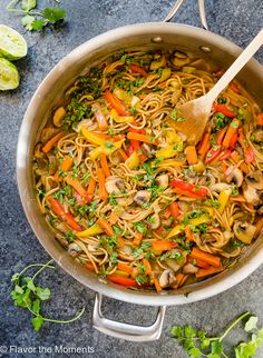 a pot filled with noodles and vegetables on top of a table