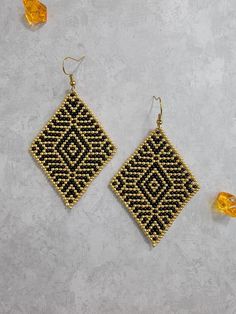 "Stunning, elegant, Black and Gold diamond shaped dangle earrings for pierced ears. I handmade these beautiful, beaded earrings using a pattern by the designer \"SpendidBeads.\"They are a 2\" wide, 3\" long dangle earring made using small size 11 round seed beads. The ear wires I use are all either silver plated Brass or 18c Gold plated Brass for those with metal sensitivities. I offer a slightly smaller version made using size 11 Miyuki Delica beads on my website www.bedazzledearrings.com. I of Black Teardrop Beaded Earrings, Handmade Elegant Diamond-shaped Earrings, Teardrop Black Beaded Earrings As Gift, Teardrop Black Beaded Earrings For Gift, Gold Drop Earrings With Black Beads, Black Beaded Teardrop Earrings For Gift, Teardrop Earrings With Black Beads For Gifts, Miyuki Delica Beads, Gold Dangle Earrings