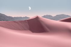 the desert is covered in pink sand and there are mountains in the distance with a half moon