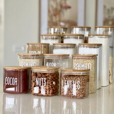 several jars filled with nuts on top of a counter