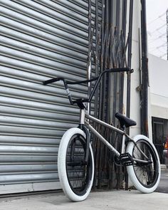 a black and silver bike parked next to a building