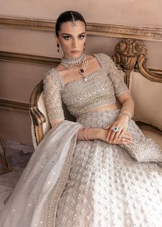 Bridal Grey Lehenga Choli Dupatta Dress for Wedding is a hand-embellished masterpiece that gives the gorgeous bride a head-turning appearance on the big day. Luxury designs and premium details on this stunning Bridal Lehenga Choli make it an epitome of royalty and grace. Choli: Beautiful choli in a classic grey shade is an exquisite choice to pair with Lehenga. The choli comes in organza fabric and is embellished with stones, sequins, and zardosi. Intricate designs, silverwork, and beaming detai Organza Choli, Nikkah Brides, Kanwal Malik, Grey Lehenga, Dupatta Dress, Lehenga Dress, Nikah Dress, Choli Dress, Silver Blouse