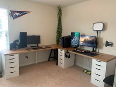 a computer desk with two monitors on top of it