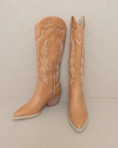 Designed meticulously with intricate cutouts and two-toned embroidery, the Ainsley cowboy boots are in a category of their own.Shaft Height: 14.5" Heel Height: 2.5"The front platform: Types of closures: ZipperCircumference of shoe opening: 15"Shaft circumference: 13"- Style: Western- Silhouette: Tall Boots- Embellishment: Embroidery - Care Instruction: Use a soft cloth and a little lukewarm water to clean the footwear after use. If necessary, add a small amount of mild soap.Carefully wipe off so Western Embroidered Boots For Rodeo, Brown Embroidered Western Boots, Western Style Beige Heeled Boots, Embroidered Snip Toe Boots For Rodeo, Spring Embroidered Boots For Rodeo, Embroidered Brown Boots With Pointed Toe, Fall Rodeo Embroidered Boots, Brown Embroidered Boots With Pointed Toe, Brown Embroidered Pointed Toe Boots