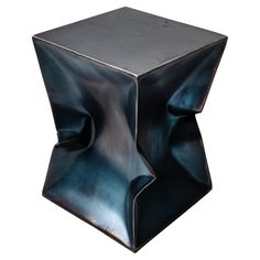 a square metal table with an unusual design