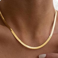 Gold Snake Chain Necklace – Sleek and Timeless Elegance Embrace the allure of understated luxury with our Gold Snake Chain Necklace. This sleek, polished chain drapes effortlessly around your neck, offering a refined touch to any ensemble. Its versatile design makes it perfect for layering or wearing solo, adding a sophisticated finish to both casual and formal looks. 18k Gold Plated Brass Gold Snake Link Chain Measures 14 Inches with an additional 3 Inch Extention Thickness 3.1 mm Lobster Clasp Elegant Chain Necklace For Everyday Luxury, Elegant Gold Herringbone Necklace For Formal Occasions, Classic Herringbone Snake Chain Necklace, Chic Herringbone Necklace With Adjustable Chain, Elegant Gold Herringbone Necklace As Gift, Elegant Box Chain Necklace, Elegant Gold Herringbone Necklace Gift, Elegant Formal Herringbone Chain Necklace, Elegant Formal Herringbone Necklace