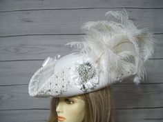 "Beautiful made to order white woolen wedding pirate hat with handsewn white Venise lace around the brim with hand placed glass rhinestones that sparkly in the light, two white satin bows, white satin cocarde with a large sparkly jewel and a waterfall of white ostrich feathers. This hat is so pretty and was a labor of love. Perfect for a pirate themed wedding. The brim of the hat is 4\" folded up. This is not an oversized pirate hat. This hat is 22.5\" for the inside circumference. This hat has a built-in hat adjuster, just cinch and tie for a tighter fit. I cannot make the circumference bigger so please keep that in mind. Please measure your head before ordering as I do not take returns as all sales are final. Check out my other pirate hats and other goodies in my etsy shop. Thank you for Handmade White Wedding Costume Hats And Headpieces, White Handmade Wedding Costume Hats And Headpieces, Handmade White Mini Hats For Wedding, Handmade White Wedding Hat, Handmade White Wedding Headpieces, Steampunk Pirate Female, Musketeer Costume, Tricorn Hat, Sea Fashion