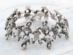 This ornate vintage bracelet is a timeless piece of jewelry crafted from sterling silver, featuring an ornate link design for an elegant finish. Perfect for any occasion, this exquisite bracelet is sure to make a statement.Metal: Sterling SilverWidth: 35.3 mmInside Circumference: 8 InchesMarks: ".925 BAS" Stamped on the clasp Classic Metal Bracelet With Intricate Design, Classic Metal Bracelets With Intricate Design, Elegant Oxidized Antique Silver Sterling Bracelet, Classic Sterling Silver Bangle With Intricate Design, Classic Sterling Silver Bracelet With Intricate Design For Wedding, Elegant Sterling Silver Bracelet With Intricate Design, Formal Sterling Silver Bangle With Oxidized Finish, Elegant Metal Bracelets With Oxidized Finish, Elegant Engraved Antique Silver Bracelets