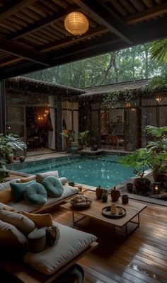 an outdoor living room with a pool in the middle and lots of furniture around it