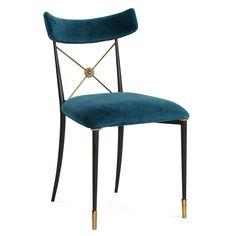 a blue velvet chair with gold legs