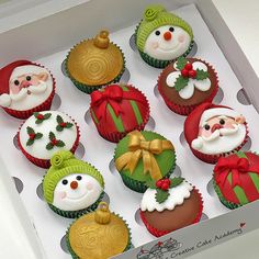 twelve cupcakes decorated as santa claus and snowmen in christmas hats, with decorations on them