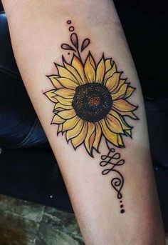 a sunflower tattoo on the arm