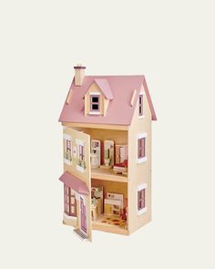 a doll house with pink roof and windows