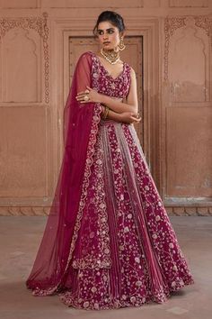 Raspberry lehenga with cutdana embellished floral motifs. Comes with embellished blouse and dupatta.
Component: 3
Embellished
Neckline: V neck
Sleeve Length: Sleeveless
Fabric: Net
Color: Pink
Blouse with criss cross detail at the waist
Cutwork at the neckline
Scallop detail at hem
Embellished dupatta with scalloped border
Closure: Side hook with tie up - Aza Fashions Kali Lehenga, Sari Lehenga, Designer Bridal Lehenga, Desi Wear, Pink Lehenga, Bridal Lehengas, Embroidered Dupatta, Embellished Blouse, Indian Couture