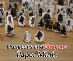 some paper minis are sitting on a table with the words, dragon's and dragons