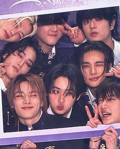 the group of young men are posing together for a photo in front of a purple frame