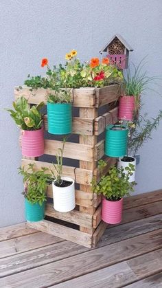 a wooden pallet filled with potted plants