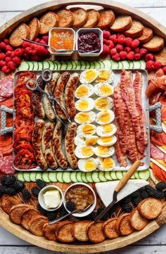 a platter with eggs, sausages and other foods