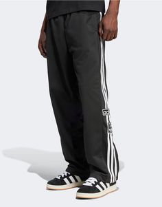 Pants & Chinos by adidas Originals Off-duty mood Regular rise Elasticated drawstring waist Side pockets adidas branding Press-stud side panels Relaxed fit Adidas Relaxed Fit Jogging Bottoms, Adidas Relaxed Fit Athleisure Joggers, Relaxed Fit Athleisure Adidas Joggers, Casual Relaxed Fit Sweatpants With Three Stripes, Adidas Relaxed Fit Sweatpants, Cotton Relaxed Fit Pants With Adidas Logo, Branded Relaxed Fit Sportswear Joggers, Sporty Joggers With Three Stripes And Relaxed Fit, Relaxed Fit Sportswear Bottoms With Three Stripes