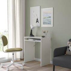 a white desk and chair in a room with wood flooring next to a window