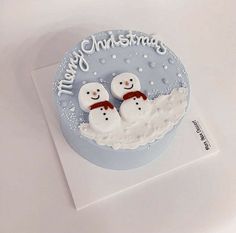 there is a cake with two snowmen on it