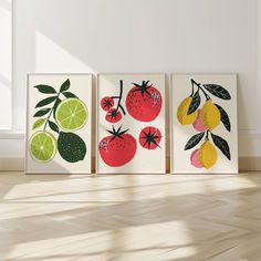 three framed art prints with lemons, oranges and limes on white walls