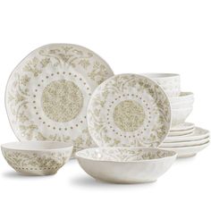 a white and gold dinner set on a white background