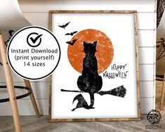 a black cat sitting on top of a broom next to an orange and black poster