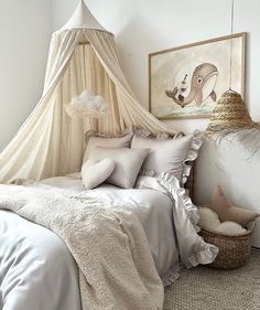 a bed with white sheets and pillows in a bedroom next to a painting on the wall