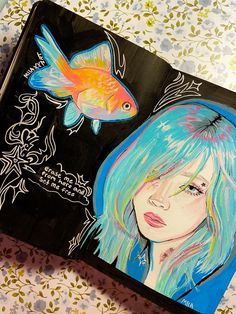 a drawing of a girl with blue hair next to a goldfish