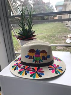 Mexican hand painted hat. The hat has a colorful floral design. Unique, colorful and fun to wear. The hat is made out of jute and it is light weight. Adjustable Multicolor Panama Hat For Spring, Handmade Toquilla Straw Panama Hat For Spring, Spring Handmade Panama Hat In Toquilla Straw, Multicolor Straw Hat For Spring Festival, Spring Festival Multicolor Straw Hat, Multicolor Spring Festival Straw Hat, Colorful Sun Hat With Curved Brim For Spring, Multicolor Fedora Straw Hat For Spring, Multicolor Flat Brim Panama Hat For Spring