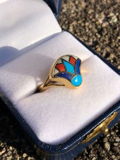 This is a fabulous vintage 14k Egyptian lotus ring with inlaid lapis, turquoise, and coral stones. The top sits a little tall on the finger. There is an Egyptian hallmark on the bezel (see photo). Striking colors and a symbolic motif. Weighs 4.7g US size 6 Egyptian Lotus, Lotus Ring, Night At The Museum, Turquoise And Coral, Coral Stone, Rings Statement, Gold Bands, Statement Rings, Egypt