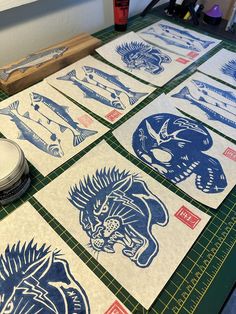 several blue and white paper cut designs on a table