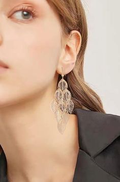 These exquisite earrings effortlessly blend timeless elegance with contemporary flair, making them an exceptional addition to your jewelry collection.Crafted with intricate attention to detail, these earrings feature a captivating multilayer hollow leaf design that dangles gracefully, creating a mesmerizing sense of movement with every step you take. The delicate filigree work showcases a level of craftsmanship reminiscent of bygone eras, adding a touch of nostalgia to your look.These earrings a Elegant Leaf-shaped Earrings, Plated Chandelier Drop Earrings, Elegant Leaf-shaped Jewelry For Party, Elegant Leaf-shaped Party Jewelry, Elegant Leaf-shaped Earrings For Party, Elegant Single Leaf Earring, Elegant Leaf-shaped Party Earrings, Elegant Leaf-shaped Metal Earrings, Elegant Leaf-shaped Jewelry