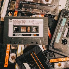 an assortment of old and used cassette tapes