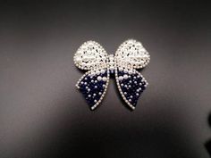 Silver Bow Brooch For Wedding, White Decorative Bow Jewelry For Wedding, White Jewelry With Decorative Bow For Wedding, White Wedding Jewelry With Decorative Bow, White Rhinestone Brooches For Formal Occasions, Elegant Rhinestone Pins For Wedding, Formal White Brooches With Rhinestones, Elegant Crystal Pins For Party, Formal White Rhinestone Brooches