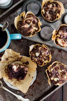 chocolate cupcakes in muffin tins with coffee