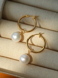 Experience elegant simplicity with our Baroque Pearl Drop Hoop Earrings. The near-round pearls add sophistication and versatility to any look. Celebrate the allure of natural beauty with their unique and exquisite form. Make a statement with these timeless, modern earrings. Metal: 18K Recycled Gold Plated On Brass Gemstone: Freshwater Pearl Pearl Dimensions: 11-11.5mm Dimensions: 3.5cm Weight: Single 3.5g Hoop Pearl Drop Earrings, Round Pearl Earrings, Drop Hoop Earrings, Earrings Metal, Tiger Eye Stone, Recycled Gold, Modern Earrings, Pearl Drop Earrings, Pearl Drop