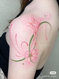 a woman's shoulder with pink flowers painted on it