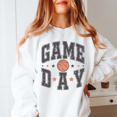 Cheer on your favorite team with this Game Day Basketball Stars Sweatshirt! It's the perfect way to show your support in any arena. Showcase your team spirit - perfect for any basketball fan! Designs are printed with direct to garment, high quality inks Graphic Print Sweatshirt For Baseball Game Day, Baseball Season Game Day Graphic Sweatshirt, Game Day Baseball Season Graphic Sweatshirt, Varsity Sweatshirt For Fall Sports Events, Fall Varsity Sweatshirt With Team Logo, Sporty White Sweatshirt For Game Day, Varsity Sweatshirt With Team Logo For Game Day, White Sporty Sweatshirt For Game Day, Fall Sports Fan Graphic Sweatshirt