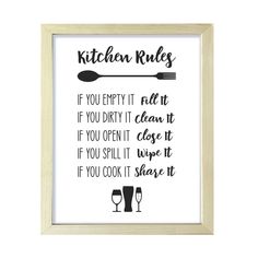 the kitchen rules print is hanging in a wooden frame