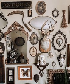 there are many antique items on the wall in this room, including an antler's head