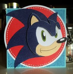 a close up of a card with an image of a sonic character on it's face