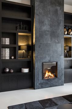 a living room with a fire place in the center and shelves on both sides that are built into the wall